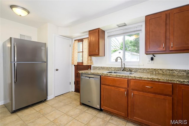 7870 Trenton Ave, University City, MO 63130 - kitchen with appliances with stainless steel finishes and light stone counters
