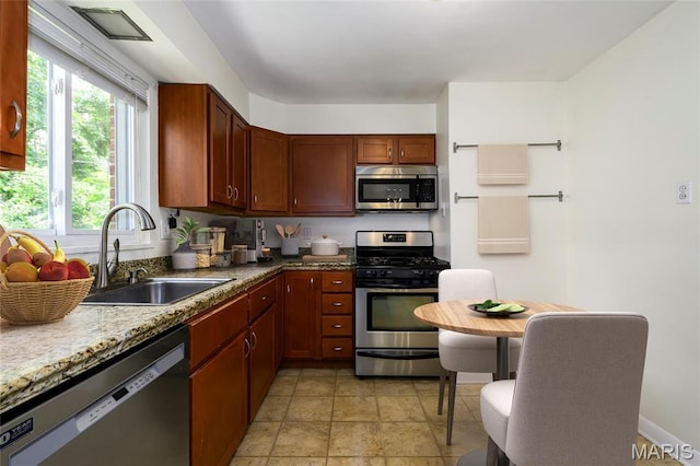 7870 Trenton Ave, University City, MO 63130 - kitchen featuring stainless steel appliances and light stone finish floors