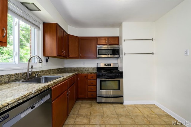 7870 Trenton Ave, University City, MO 63130 - kitchen with appliances with stainless steel finishes and stone countertops
