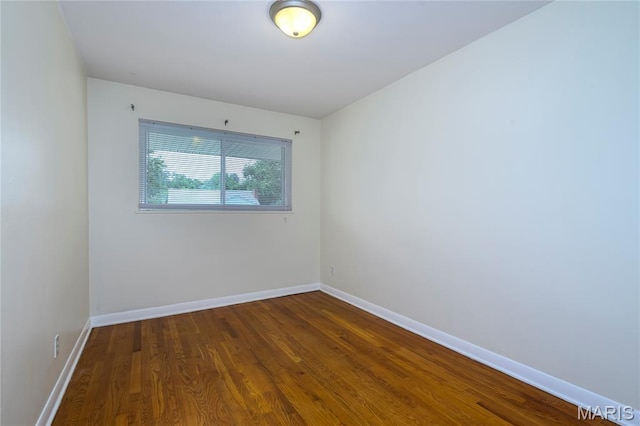 7870 Trenton Ave, University City, MO 63130 - spare room featuring dark wood finished floors and baseboards