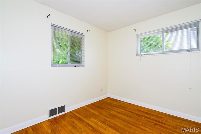 7870 Trenton Ave, University City, MO 63130 - spare room featuring baseboards and wood finished floors