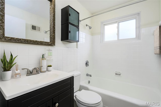 7870 Trenton Ave, University City, MO 63130 - full bathroom featuring vanity,  shower combination, and tile walls