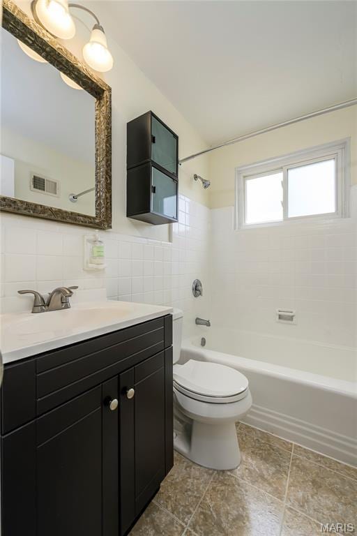 7870 Trenton Ave, University City, MO 63130 - full bathroom with tile walls, vanity, and  shower combination