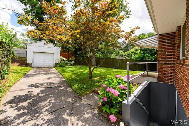 7870 Trenton Ave, University City, MO 63130 - view of yard with an outdoor structure, concrete driveway, and a garage