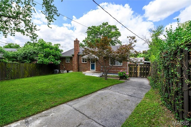 7870 Trenton Ave, University City, MO 63130 - view of front of house featuring brick siding, asphalt driveway, and a chimney