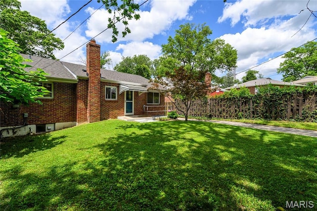 7870 Trenton Ave, University City, MO 63130 - rear view of property featuring brick siding, a chimney, and roof with shingles