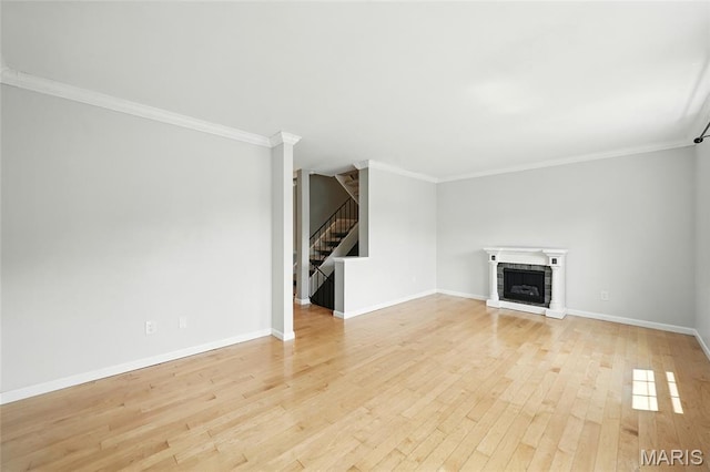 811 Wendevy Ct, Ballwin, MO 63011 - unfurnished living room featuring stairs, light wood-type flooring, crown molding, and a fireplace with raised hearth