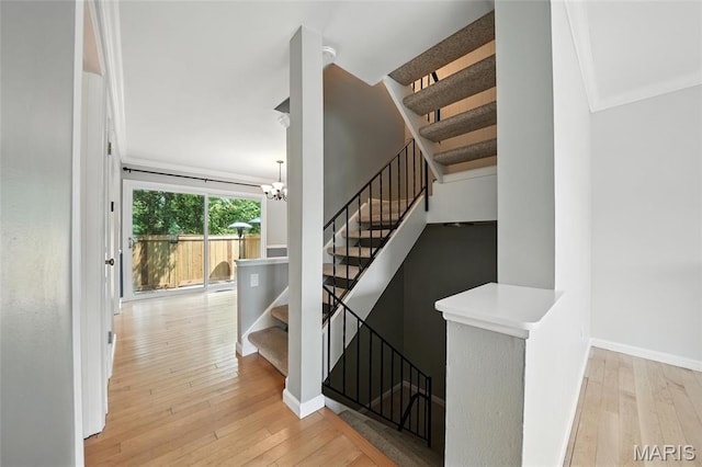 811 Wendevy Ct, Ballwin, MO 63011 - stairs featuring hardwood / wood-style flooring and a chandelier