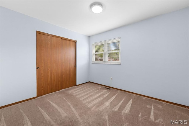 1203 Summerwood Dr, Saint Peters, MO 63376 - unfurnished bedroom featuring a closet and carpet flooring