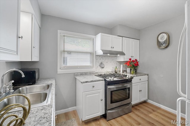 135 Anabel Ave, Saint Louis, MO 63135 - kitchen featuring stainless steel gas stove, under cabinet range hood, a sink, light countertops, and light wood-style flooring