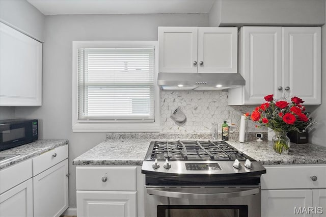 135 Anabel Ave, Saint Louis, MO 63135 - kitchen featuring stainless steel gas range oven, under cabinet range hood, black microwave, white cabinetry, and light stone countertops