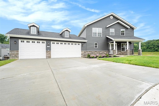 685 Fox Creek Dr, Fenton, MO 63026 - view of front of property with stone siding, covered porch, driveway, a front yard, and an attached garage