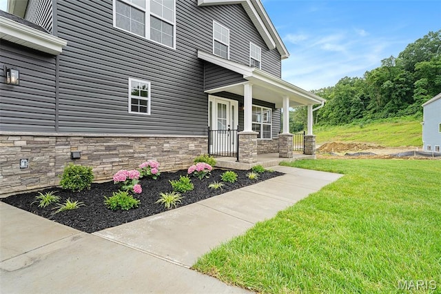 685 Fox Creek Dr, Fenton, MO 63026 - property entrance featuring stone siding, covered porch, and a lawn