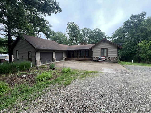 32 Bobwhite Ln, Troy, MO 63379 - ranch-style house with concrete driveway, an attached garage, a chimney, stone siding, and a porch