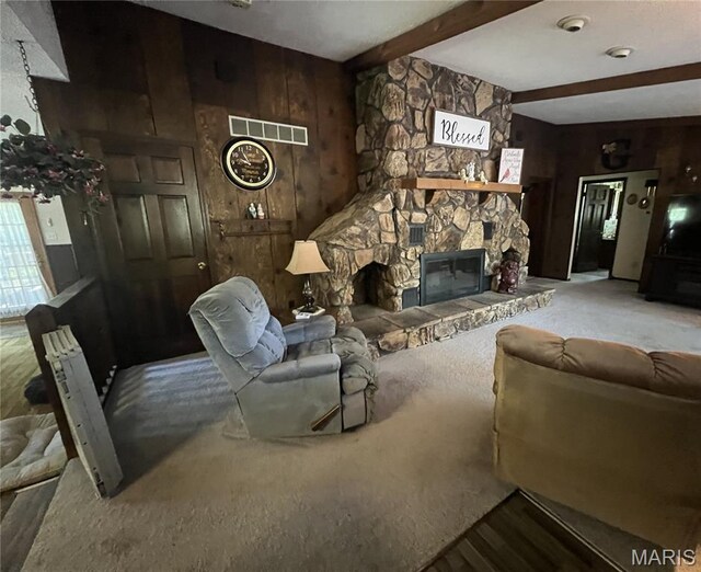32 Bobwhite Ln, Troy, MO 63379 - living room with wood walls, beamed ceiling, wood finished floors, and a stone fireplace