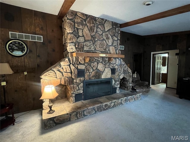 32 Bobwhite Ln, Troy, MO 63379 - carpeted living room featuring wooden walls, beam ceiling, and a stone fireplace