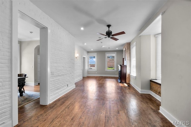309 S Spanish Cpe, Girardeau, MO 63701 - unfurnished living room featuring arched walkways, ceiling fan, wood finished floors, baseboards, and recessed lighting