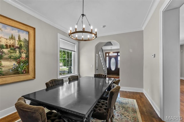 309 S Spanish Cpe, Girardeau, MO 63701 - dining space featuring arched walkways, a chandelier, dark wood-type flooring, ornamental molding, and baseboards