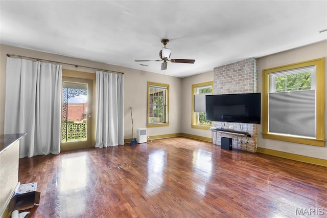 309 S Spanish Cpe, Girardeau, MO 63701 - unfurnished living room with a ceiling fan, wood finished floors, and baseboards