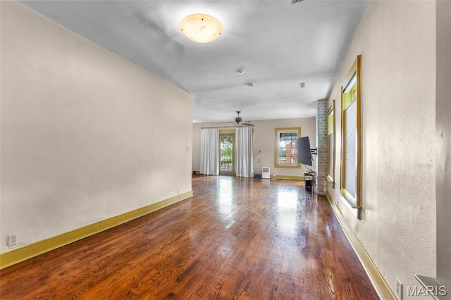 309 S Spanish Cpe, Girardeau, MO 63701 - unfurnished living room with wood finished floors, a ceiling fan, and baseboards