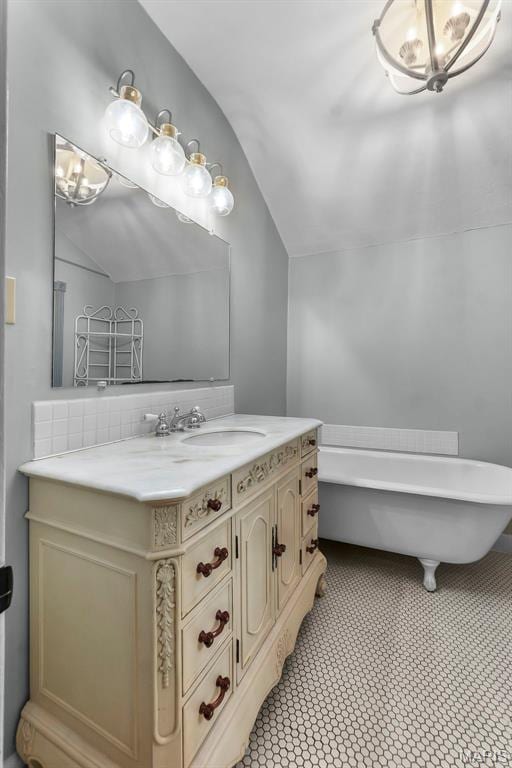 309 S Spanish Cpe, Girardeau, MO 63701 - bathroom featuring lofted ceiling, a freestanding bath, and vanity