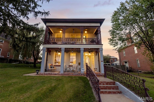 309 S Spanish Cpe, Girardeau, MO 63701 - back of property at dusk with a balcony and a porch