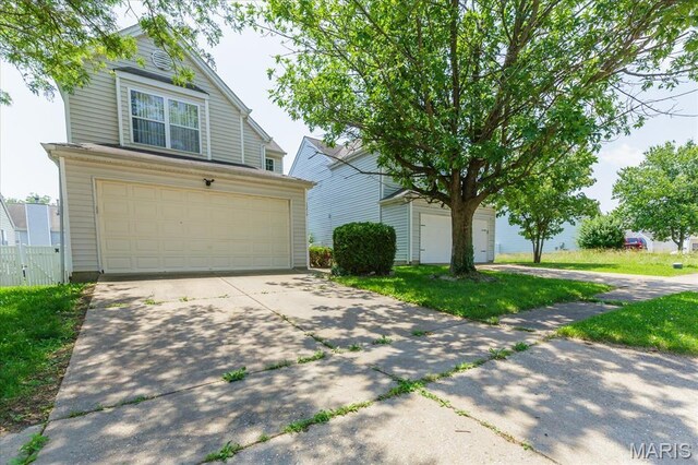 11256 Liberty Landing Dr, Florissant, MO 63033 - traditional-style home featuring concrete driveway and an attached garage