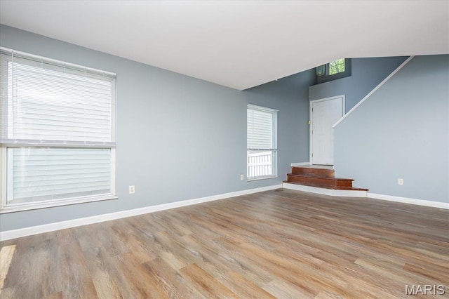 11256 Liberty Landing Dr, Florissant, MO 63033 - unfurnished living room featuring wood finished floors and baseboards