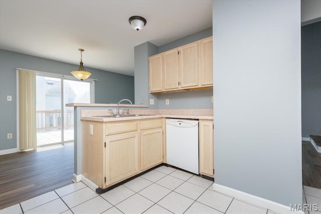 11256 Liberty Landing Dr, Florissant, MO 63033 - kitchen with dishwasher, a sink, light brown cabinetry, light countertops, and a peninsula