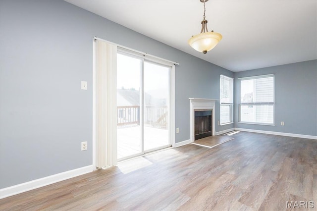 11256 Liberty Landing Dr, Florissant, MO 63033 - unfurnished living room with plenty of natural light, wood finished floors, and baseboards