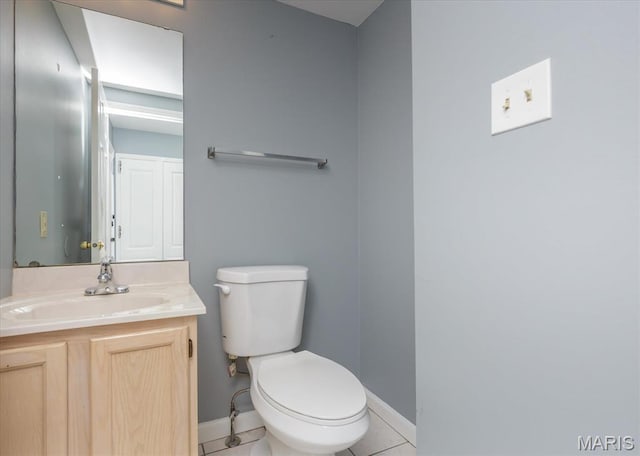 11256 Liberty Landing Dr, Florissant, MO 63033 - bathroom featuring baseboards, toilet, vanity, and tile patterned floors