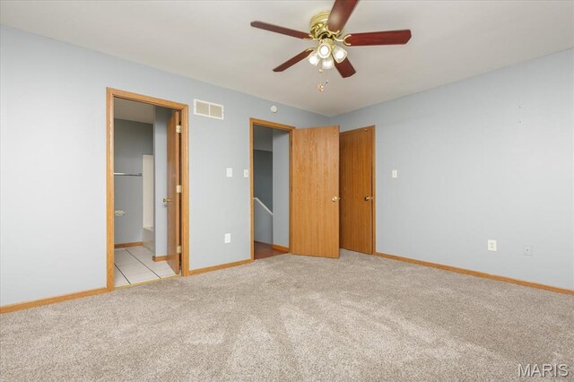 11256 Liberty Landing Dr, Florissant, MO 63033 - unfurnished bedroom with light colored carpet, baseboards, ensuite bathroom, and ceiling fan