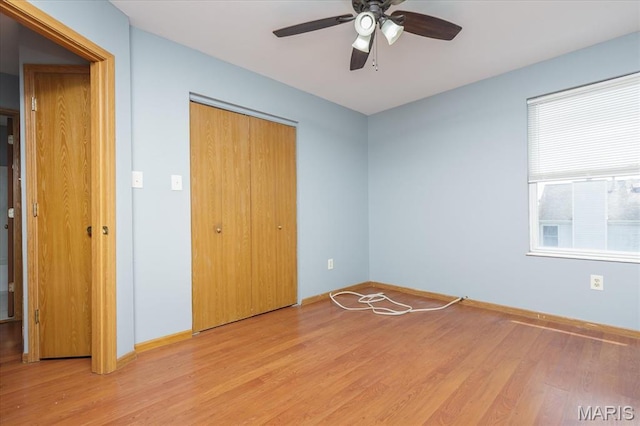 11256 Liberty Landing Dr, Florissant, MO 63033 - unfurnished bedroom with light wood-style floors, a closet, baseboards, and ceiling fan