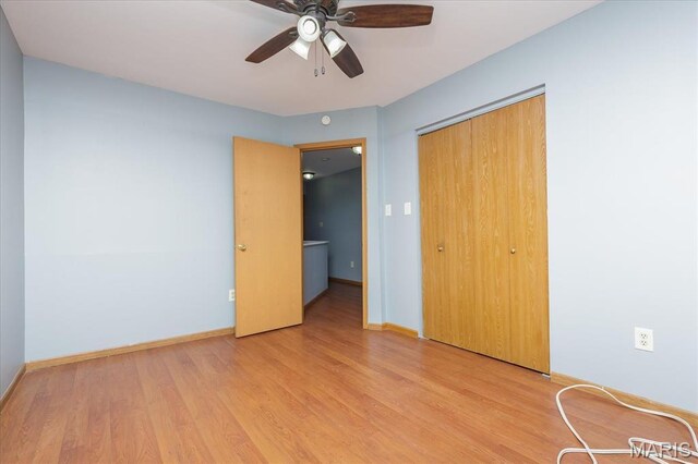 11256 Liberty Landing Dr, Florissant, MO 63033 - unfurnished bedroom featuring light wood-style flooring, a closet, baseboards, and a ceiling fan
