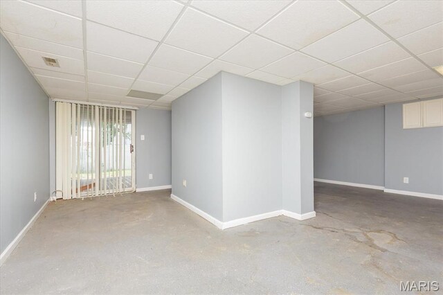 11256 Liberty Landing Dr, Florissant, MO 63033 - spare room featuring a paneled ceiling, concrete floors, and baseboards