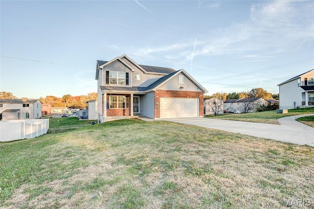 308 Ganim Dr, Shiloh, IL 62221 - traditional home featuring brick siding, concrete driveway, an attached garage, a front yard, and a porch