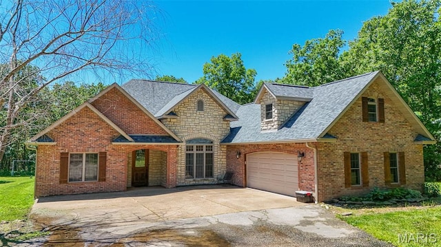 10660 Fawn Rdg, Rolla, MO 65401 - view of front of home with driveway, an attached garage, roof with shingles, stone siding, and brick siding