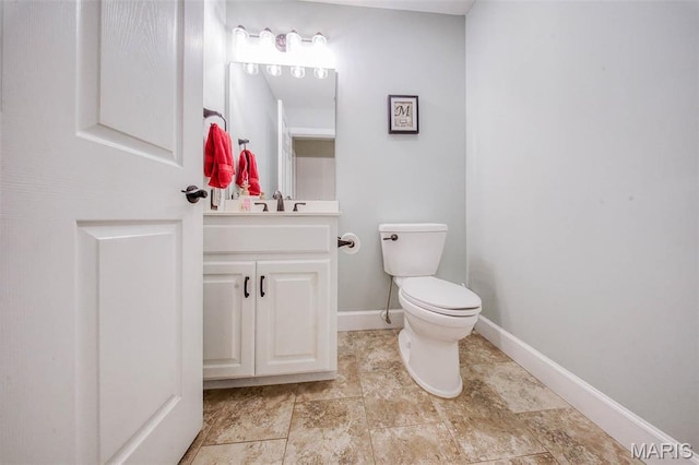 10660 Fawn Rdg, Rolla, MO 65401 - bathroom featuring vanity, toilet, and baseboards