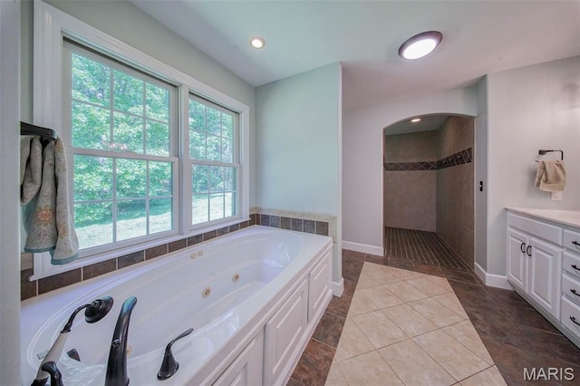10660 Fawn Rdg, Rolla, MO 65401 - bathroom featuring a walk in shower, a jetted tub, vanity, baseboards, and tile patterned floors