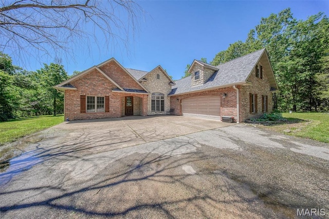 10660 Fawn Rdg, Rolla, MO 65401 - view of front of property with brick siding, an attached garage, concrete driveway, and a front yard