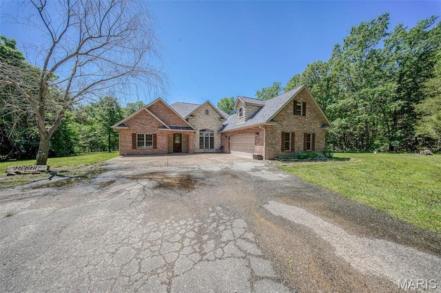 10660 Fawn Rdg, Rolla, MO 65401 - view of front of home featuring brick siding, a garage, concrete driveway, and a front yard