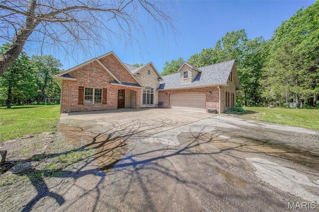10660 Fawn Rdg, Rolla, MO 65401 - traditional home featuring brick siding, a garage, a front yard, and driveway