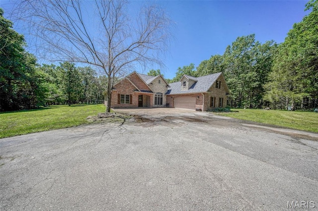 10660 Fawn Rdg, Rolla, MO 65401 - view of front of property with brick siding, a garage, a front yard, and driveway