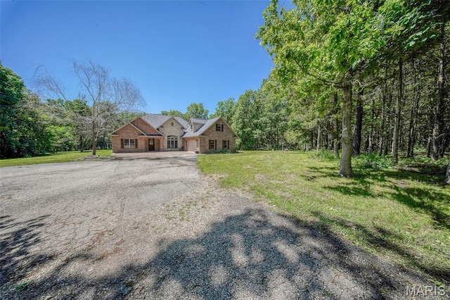 10660 Fawn Rdg, Rolla, MO 65401 - view of front of home featuring asphalt driveway, a front lawn, and a garage