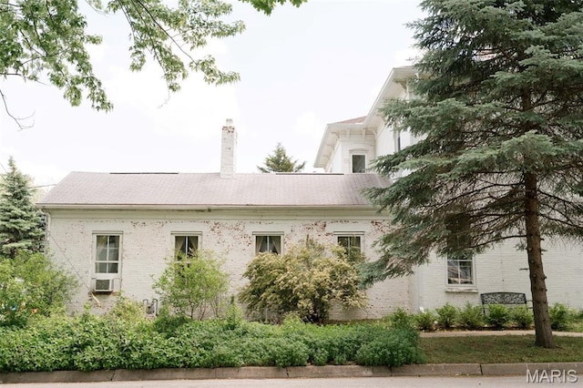 124 W Ross St, Palmyra, MO 63461 - view of side of property featuring a chimney, brick siding, and cooling unit