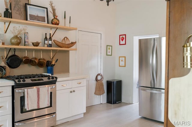124 W Ross St, Palmyra, MO 63461 - kitchen featuring appliances with stainless steel finishes, open shelves, white cabinets, and light countertops