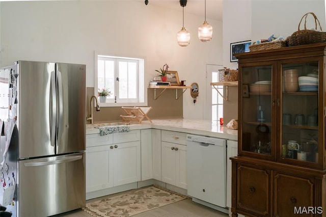 124 W Ross St, Palmyra, MO 63461 - kitchen featuring freestanding refrigerator, white dishwasher, open shelves, hanging light fixtures, and white cabinetry