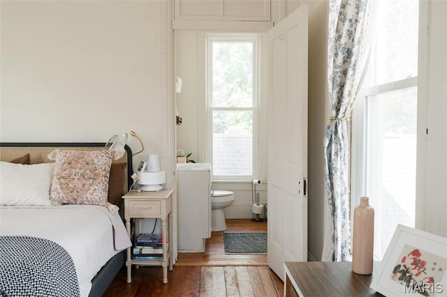 124 W Ross St, Palmyra, MO 63461 - bedroom featuring wood-type flooring, multiple windows, and ensuite bathroom