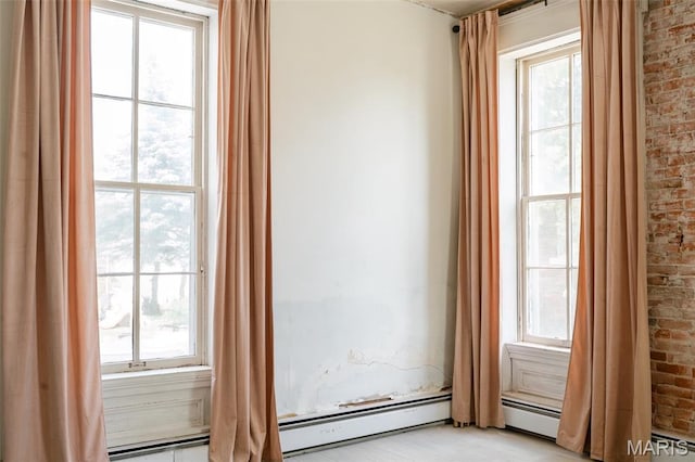 124 W Ross St, Palmyra, MO 63461 - unfurnished room with plenty of natural light and brick wall