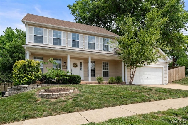 12101 Fahrpark Ln, Saint Louis, MO 63146 - colonial house featuring driveway, an attached garage, and covered porch